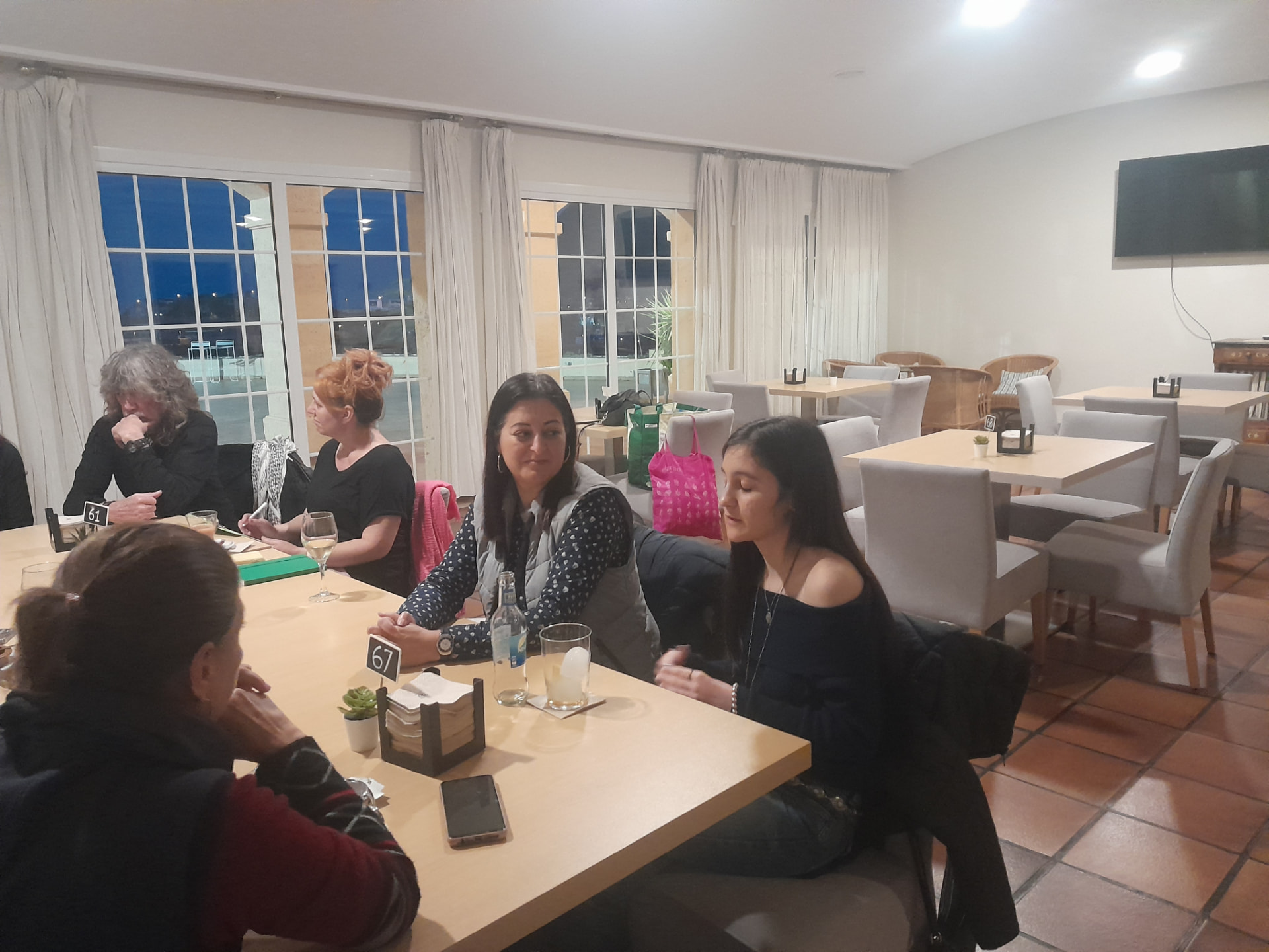 An evening session in progress, seen down the length of the table
