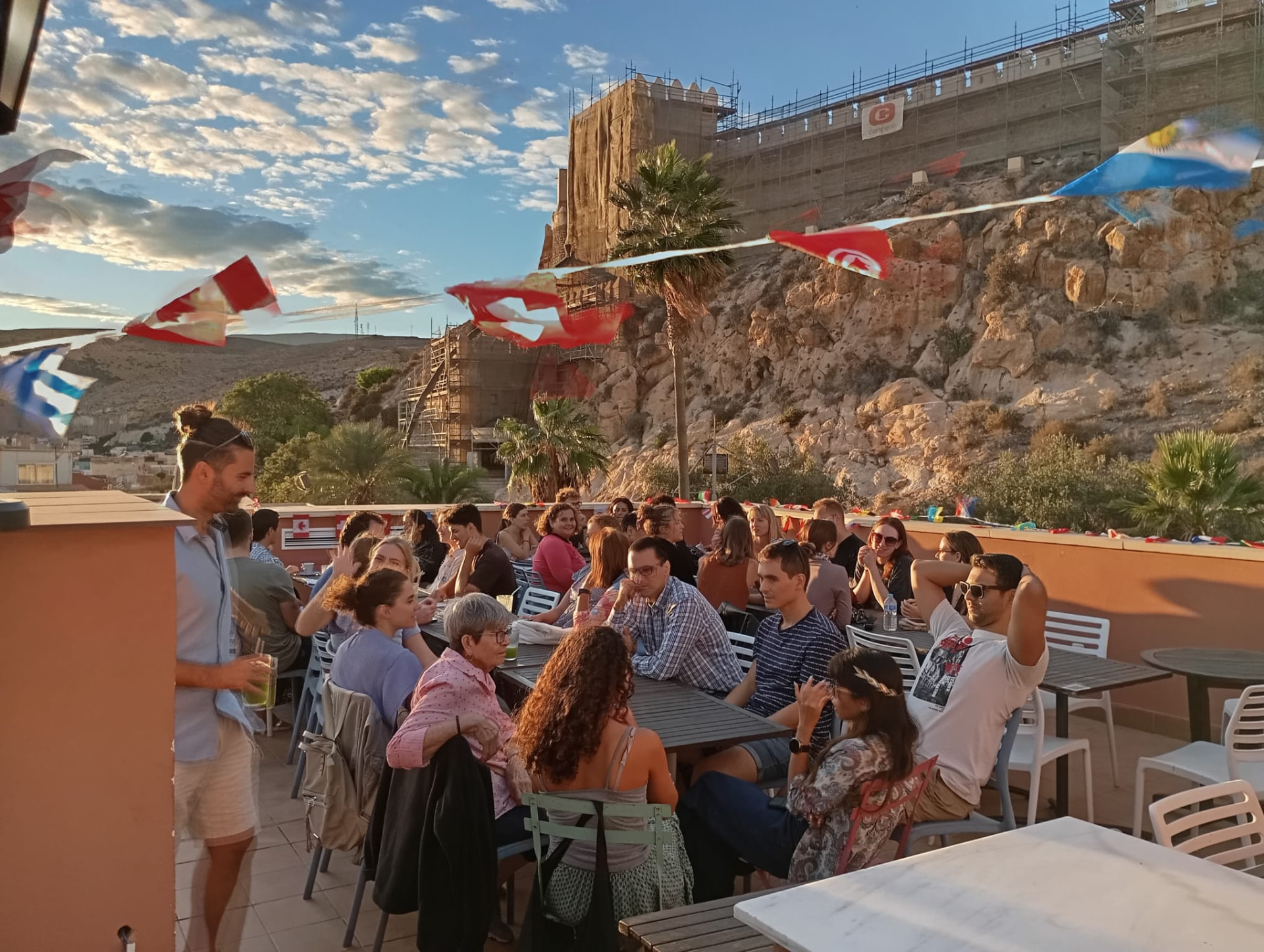 The terrace crowd beneath the Alcazaba at sunset