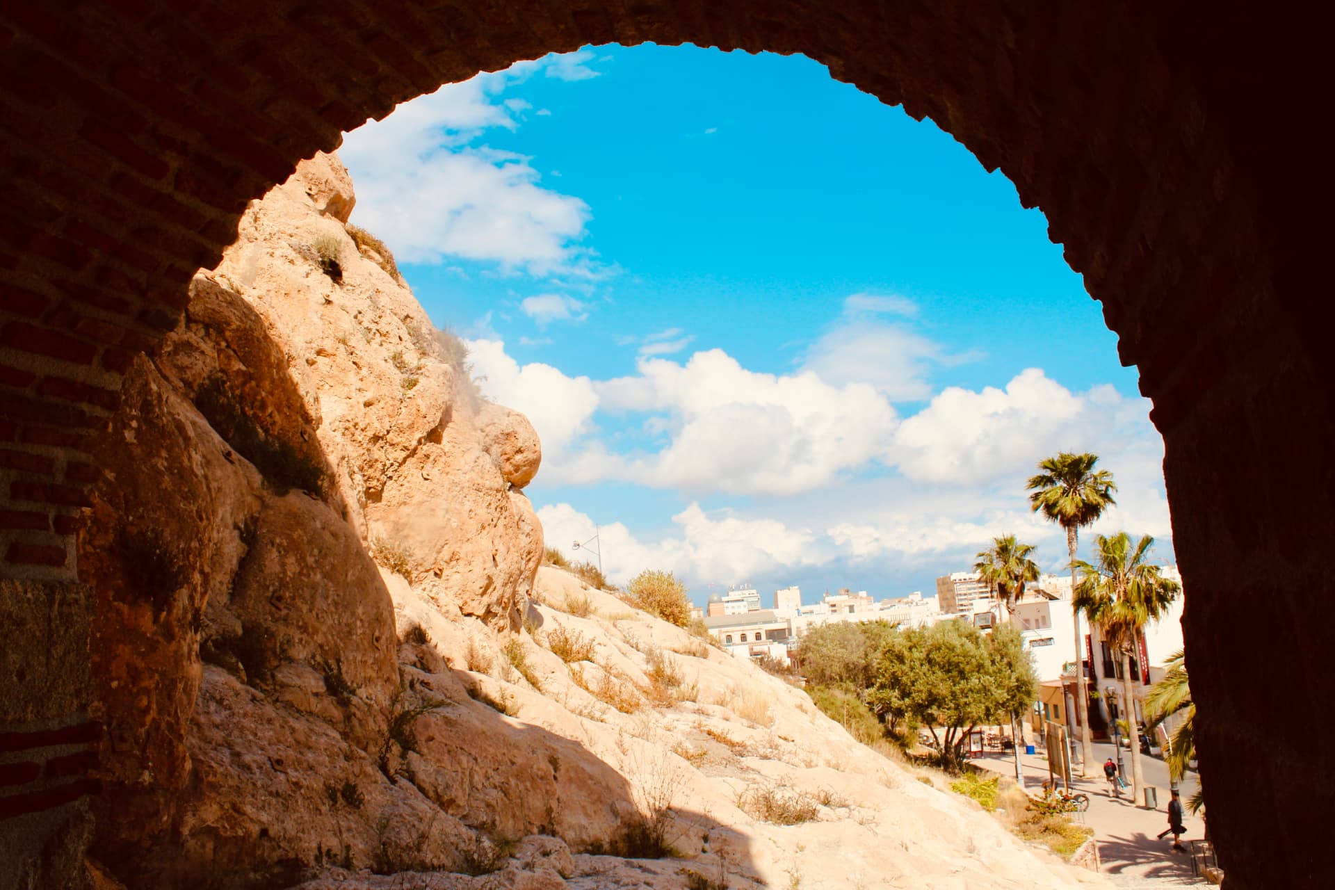 Almería seen through a historic brick arch